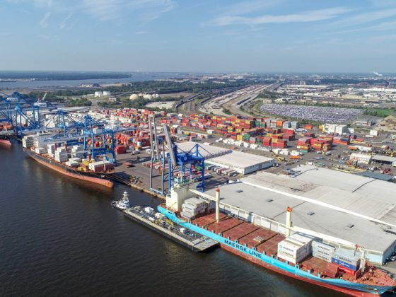 Aerial view of the maritime terminal shows dockside equipment and huge cranes.