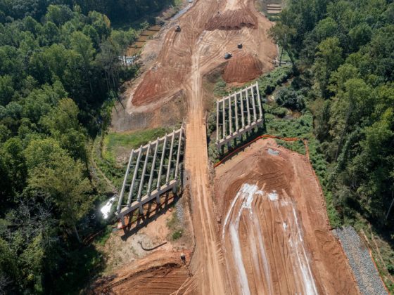 Complete 540 project bridge construction over Swift Creek.