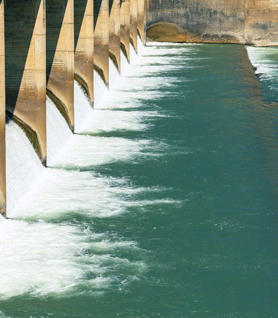 Water releasing from hydroelectric power station on a sunny day.