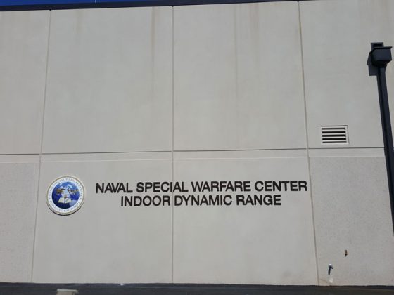 Concrete exterior of building with signage that reads “Naval Special Warfare Center Indoor Dynamic Range.”