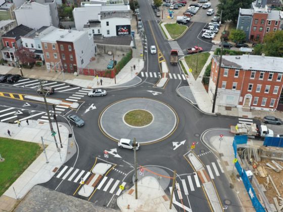 Overhead image of a single-lane roundabout in a city.