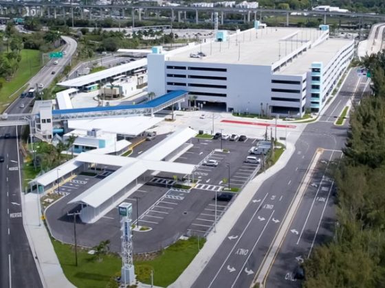 A parking garage facility with road on either side and water to the right.