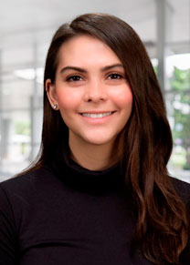 A woman with dark hair wearing a black shirt smiling for the camera.