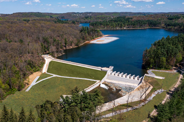 An aerial photo shows the reservoir behind a dam.