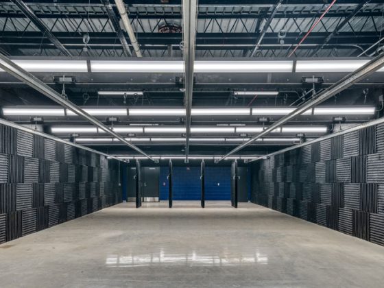 The front of the shooting range with blue painted concrete wall.