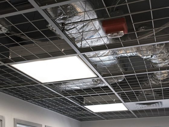 Ceiling grid with no ceiling tiles and exposed views of the mechanical and electrical systems.