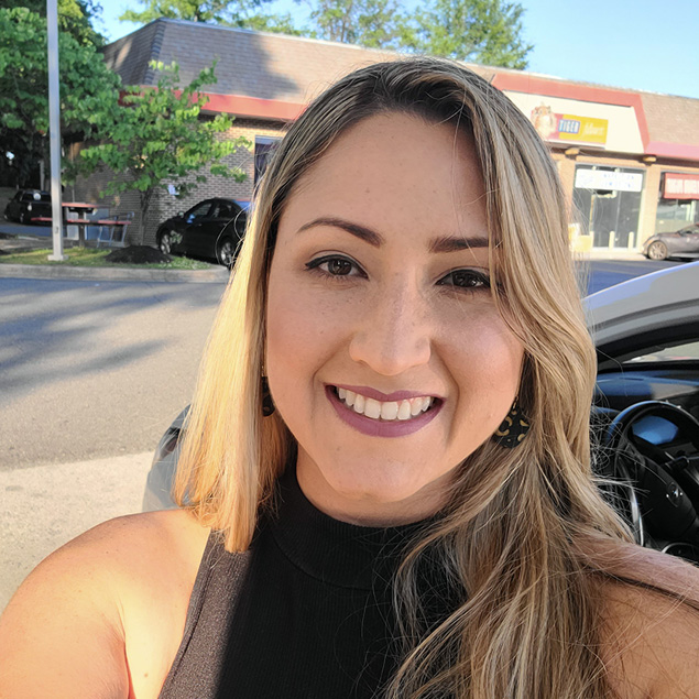 : Transportation engineering expert Ister Morales smiles at the camera while enjoying the outdoors.