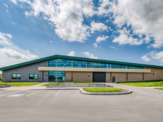 Exterior of training center showing modern brick façade and large front windows.